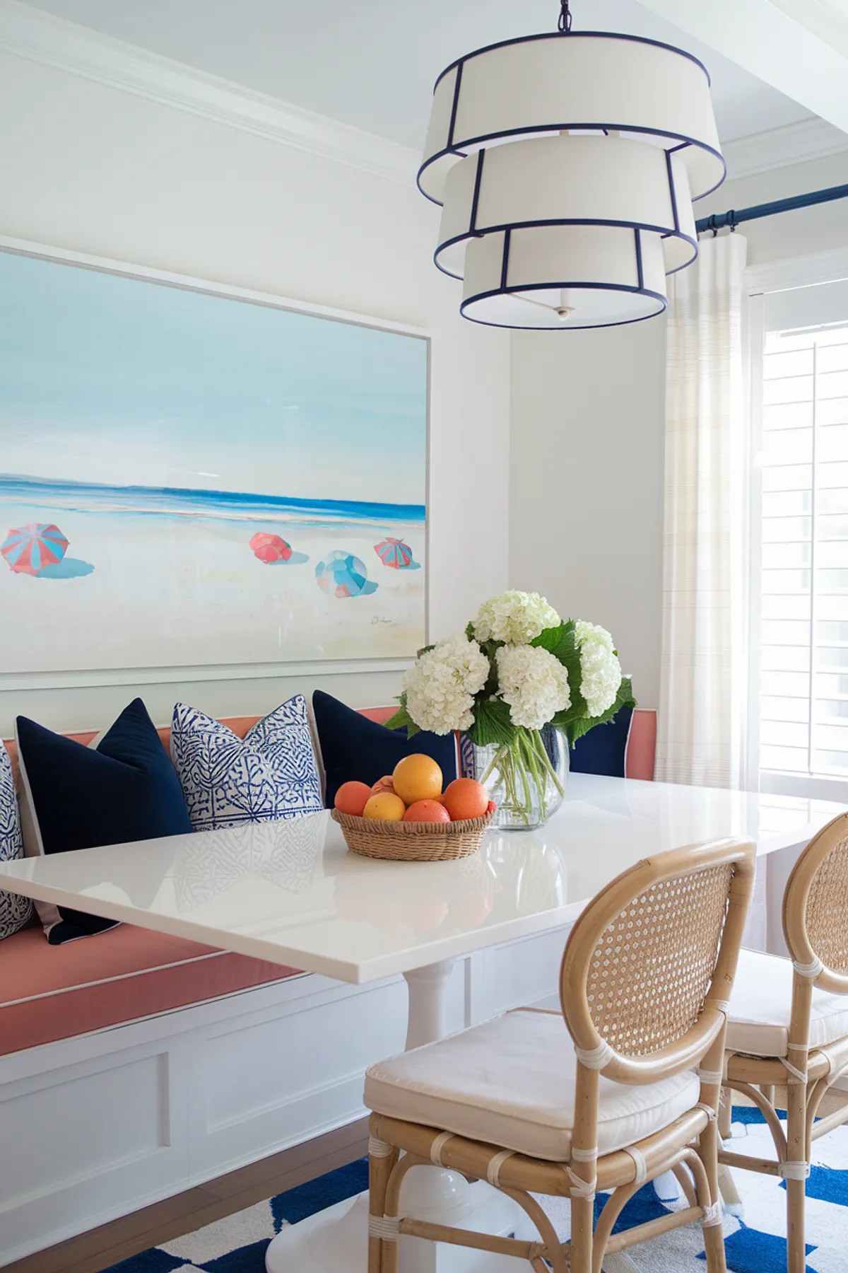 Bright dining table with citrus fruits and fresh hydrangeas in a coastal-inspired setting.