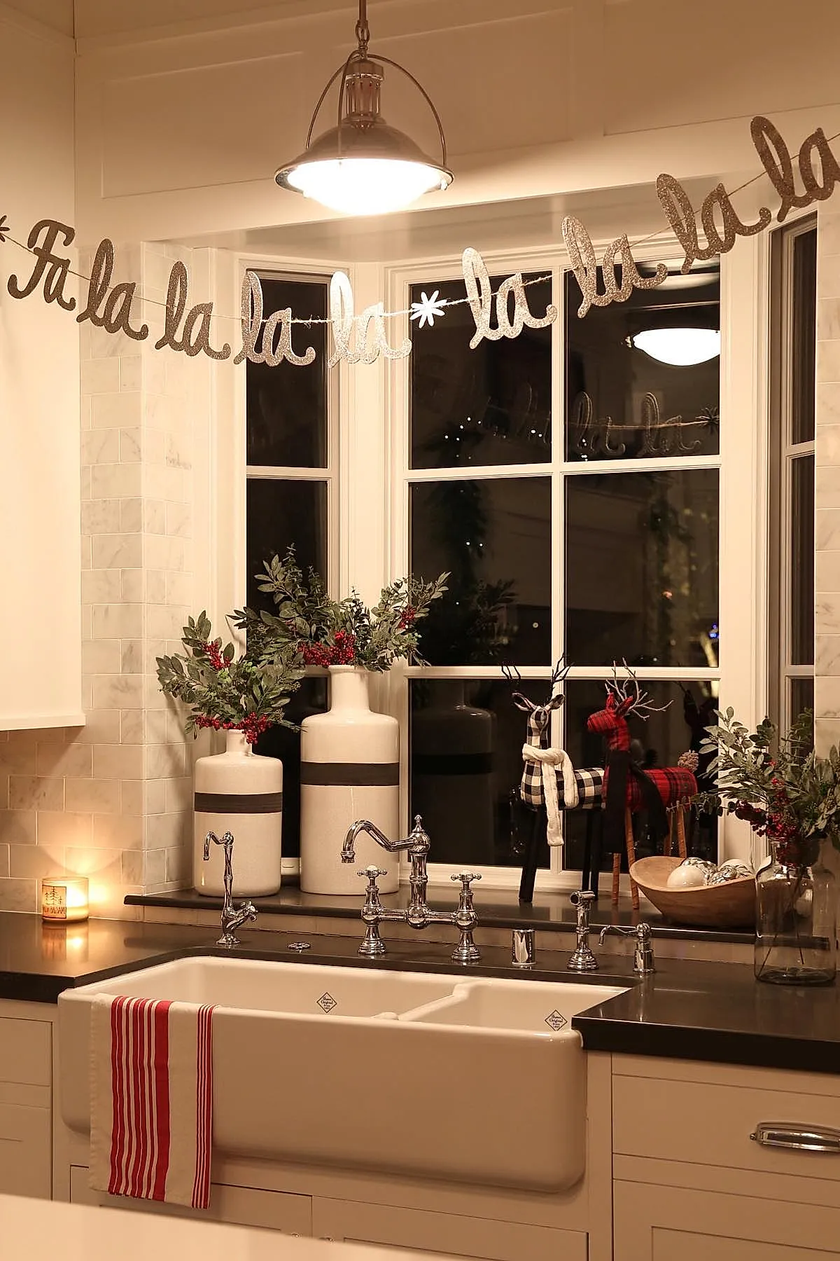 kitchen window decorated for Christmas with a sparkling silver