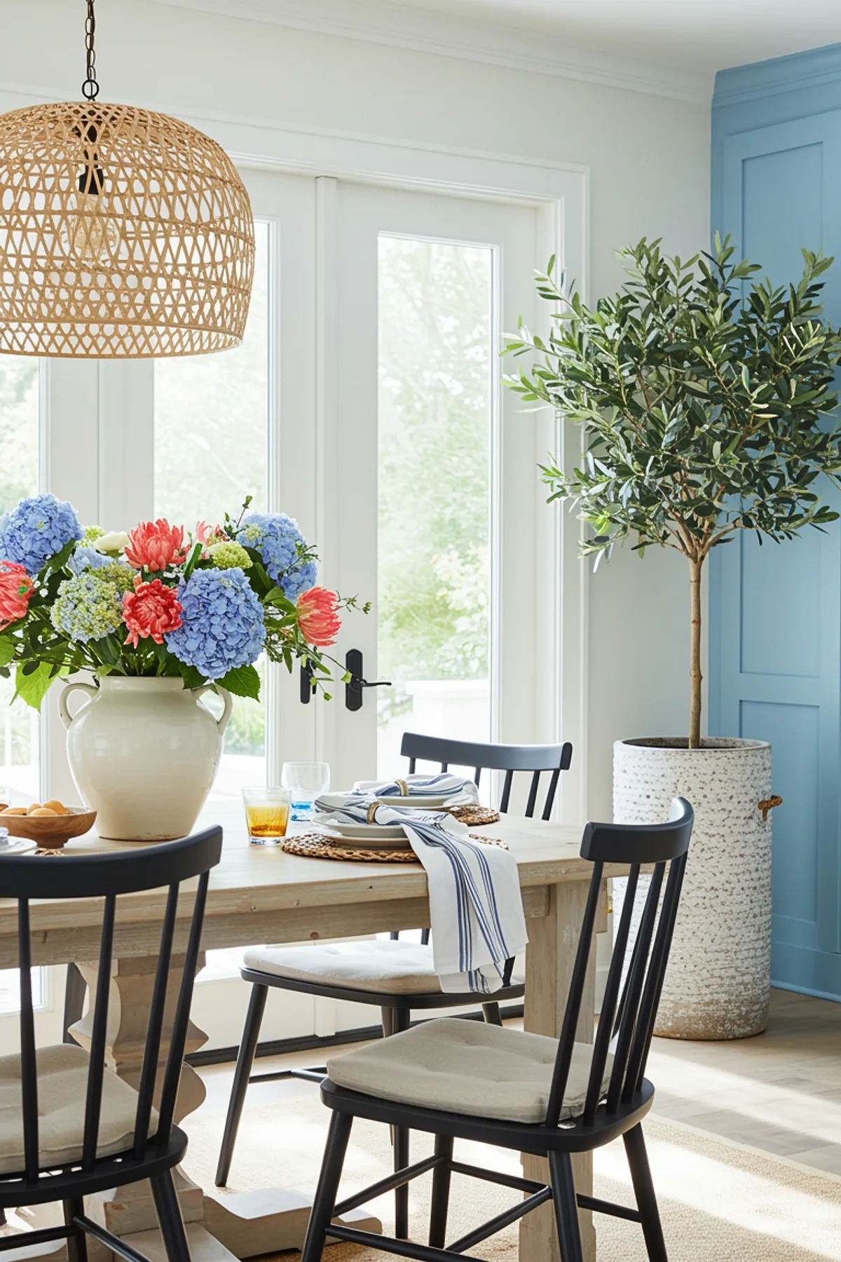 A bright dining area featuring a large floral arrangement, wooden table, and colorful decor.