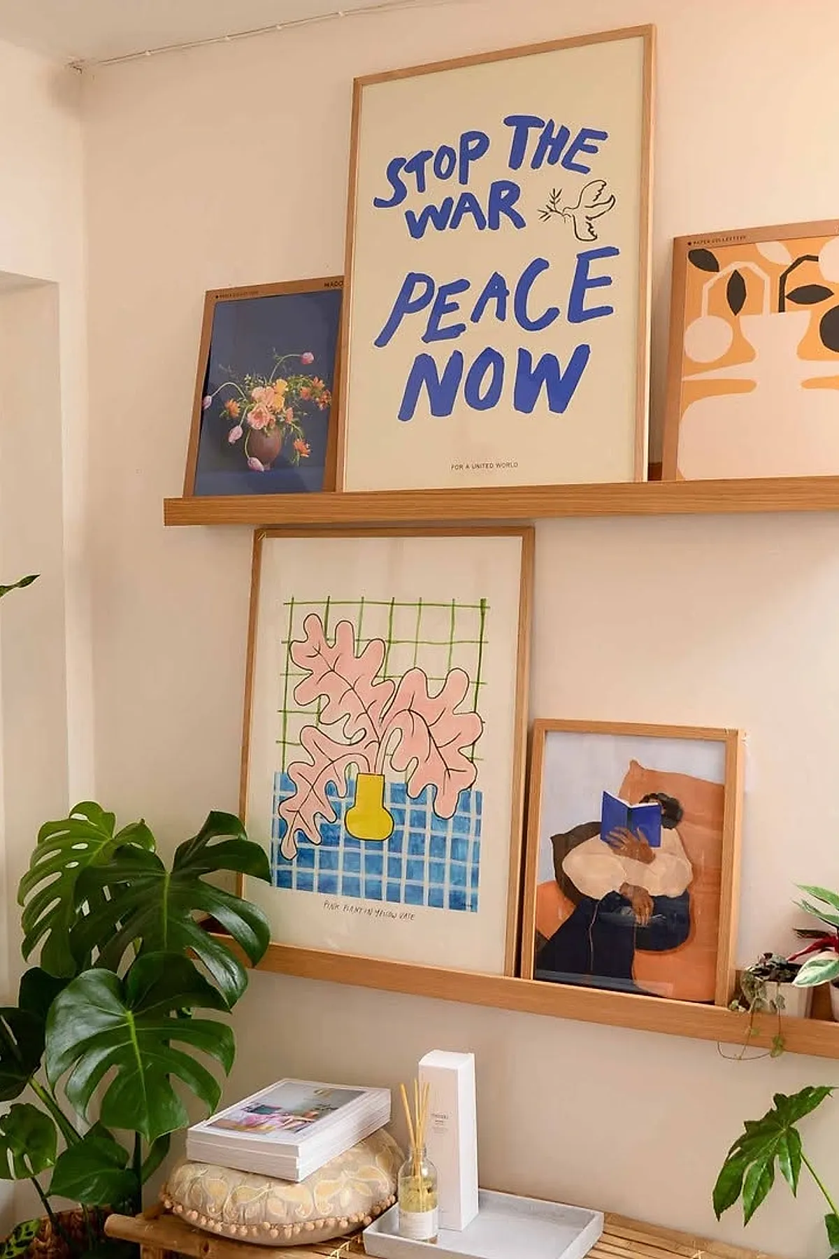 Living room wall decor ideas featuring framed artwork with bold blue text