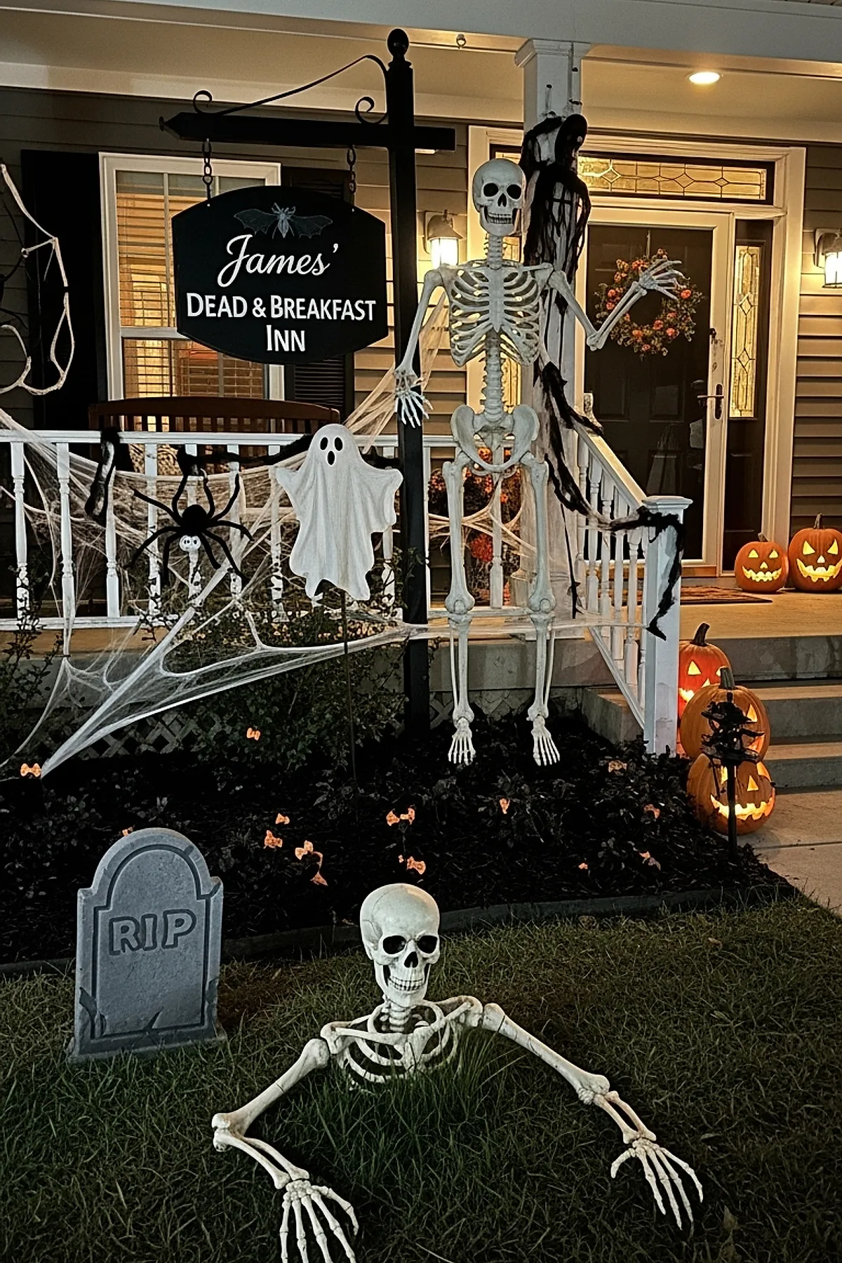 Halloween front yard decorated with black sign reading James